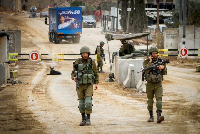 Israeli soldiers block the entrance to the village of Beita, in the West Bank on September 13, 2023, (photo credit: NASSER ISHTAYEH/FLASH90)