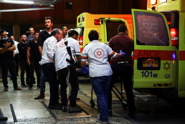 An injured man is taken off an ambulance at a hospital, following an incident near Kiryat Arba, a Jewish settlement in Hebron, in Jerusalem (photo credit: REUTERS/Ronen Zvulun)