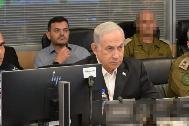   Israeli Prime Minister Benjamin Netanyahu with senior military officers in an Israeli Air Force war room, October 8, 2023. (photo credit: AMOS BEN-GERSHOM/GPO)