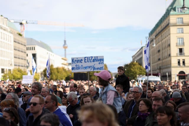  A placard reading "No EU payments to Palestinians/Hamas" is held as Israel supporters protest, following Hamas' biggest attack on Israel in years, next to the Brandenburg Gate, in Berlin, Germany, October 8, 2023. (photo credit: REUTERS/Liesa Johannssen)