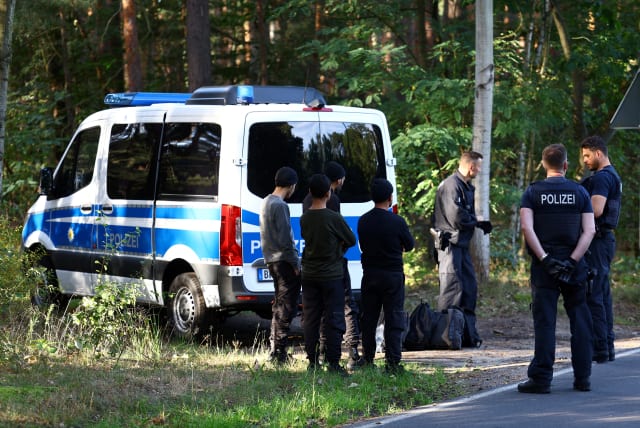 Police detain suspects as they patrol along the German-Polish border to prevent illegal migration near Klinge, Germany, September 20, 2023.  (photo credit: REUTERS/LISI NIESNER/FILE PHOTO)