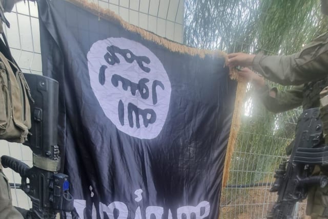  An ISIS flag seen at Israel's kibbutz Sufa following a massacre by infiltarting Hamas terrorists, pictured on October 11, 2023 (photo credit: IDF SPOKESPERSON'S UNIT)