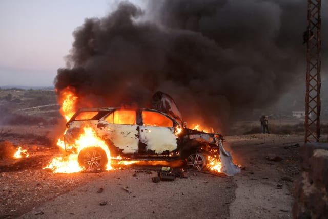  A journalist's car burns at the site where Reuters videojournalist Issam Abdallah was killed and six others were injured on Friday when missiles fired from the direction of Israel struck them, in Alma Al-Shaab, near the border with Israel, southern Lebanon, October 13, 2023.