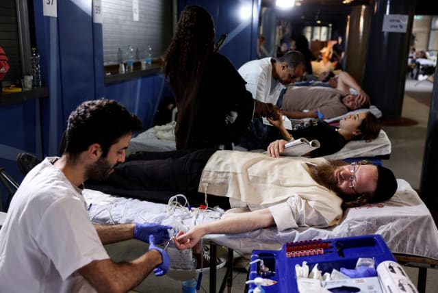  An Ultra-Orthodox Jewish man donates blood as part of a blood-drive following a mass-rampage by armed Palestinian infiltrators into Israel, in Jerusalem October 9, 2023. (photo credit: REUTERS/Ronen Zvulun)