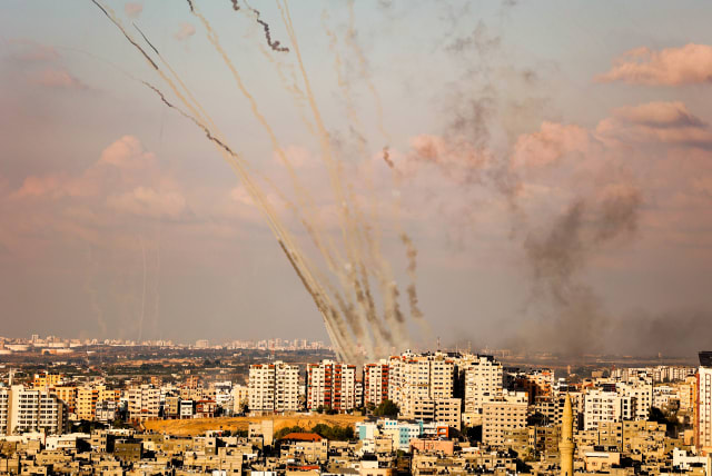  Rockets are fired from Gaza towards Israel, in the southern Gaza Strip, on October 10, 2023. (photo credit: ATIA MOHAMMED/FLASH90)