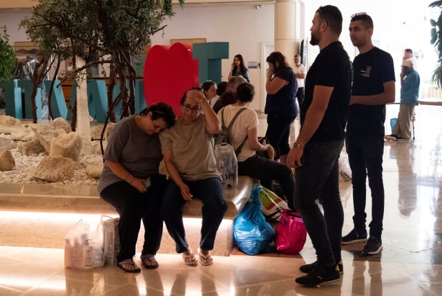  Survivors of Hamas attack on southern Israel, embrace after being evacuated to a hotel in Ein Bokek, Israel October 11, 2023. (photo credit: REUTERS)