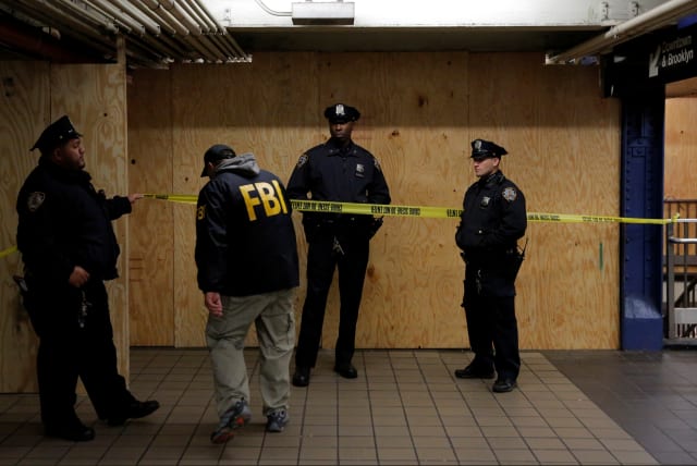  A member of the FBI enters the crime scene beneath the New York Port Authority Bus Terminal following an attempted detonation during the morning rush hour, in New York City, New York, U.S., December 11, 2017. (photo credit: REUTERS/ANDREW KELLY)