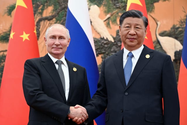  Russian President Vladimir Putin shakes hands with Chinese President Xi Jinping during a meeting at the Belt and Road Forum in Beijing, China, October 18, 2023. (photo credit: Sputnik/Sergei Guneev/Pool via REUTERS)