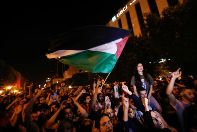 People gather during a protest after hundreds of Palestinians were killed in a blast at Al-Ahli hospital in Gaza that Israeli and Palestinian officials blamed on each other, in front of the French embassy in Tunis, Tunisia October 17, 2023 (photo credit: REUTERS/ZOUBEIR SOUISSI)