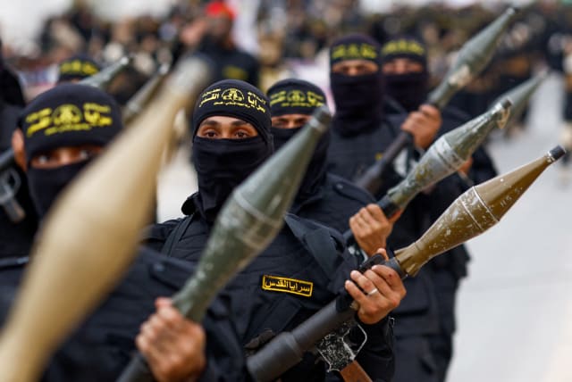  Palestinian Islamic Jihad terrorists participate in an anti-Israel military parade marking the 36th anniversary of the movement's foundation in Gaza City, October 4, 2023. (photo credit: MOHAMMED SALEM/REUTERS)