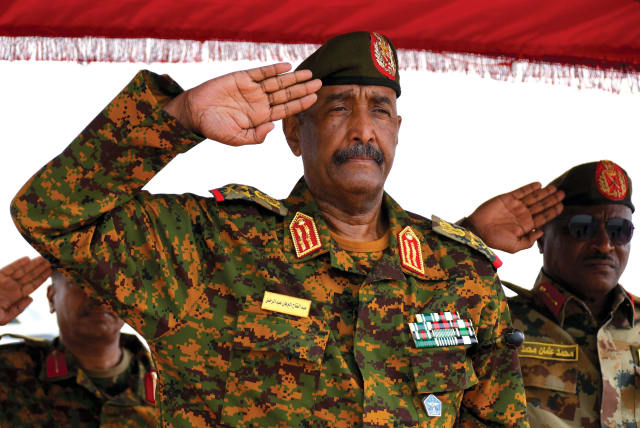  Sudan’s General Abdel Fattah al-Burhan salutes as he listens to the national anthem after landing at the military airport of Port Sudan on August 27, 2023.  (photo credit: Ibrahim Mohammed Ishak/Reuters)