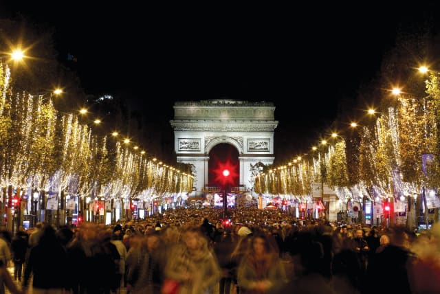  Lights along the Champs-Elysees with the Arc de Triomphe in the background. (photo credit: BENOIT TESSIER/REUTERS)