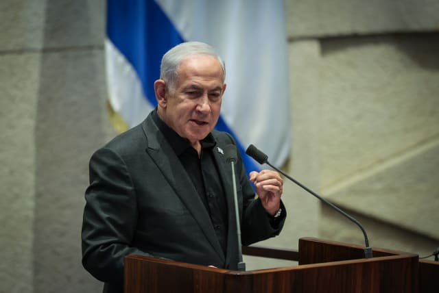  Israeli Prime Minister Benjamin Netanyahu at a special plenum session presenting the new emergency government at the assembly hall of the Knesset, the Israeli parliament in Jerusalem on October 12, 2023. (photo credit: NOAM REVKIN FENTON/FLASH90)
