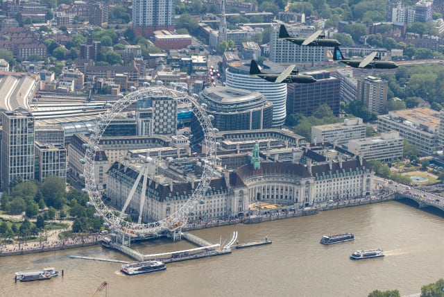C130 Hercules aircraft from RAF Brize Norton fly near the London Eye, on the day of Trooping the Colour parade to honour King Charles's official birthday, in London, Britain, June 17, 2023 (photo credit: AS1 Jake Hobbs/MOD Crown Copyright 2023/Handout via REUTERS)
