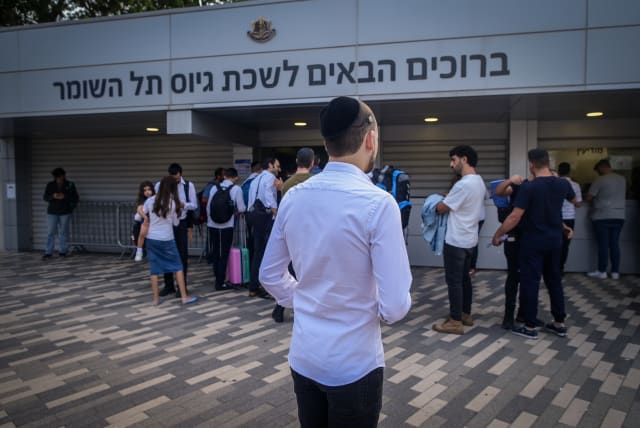  Ultra-Orthodox Jewish men who decided to join in the IDF following the ongoing war between Israel and Hamas arrive at the IDF recruiting offices in Tel Hashomer, near Tel Aviv, October 23, 2023 (photo credit: AVSHALOM SASSONI/FLASH90)