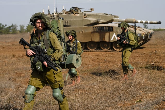 IDF reserve Infantry and Merkava Tank soldiers train in a military exercise in the Golan Heights on October 23, 2023. (photo credit: MICHAEL GILADI/FLASH90)