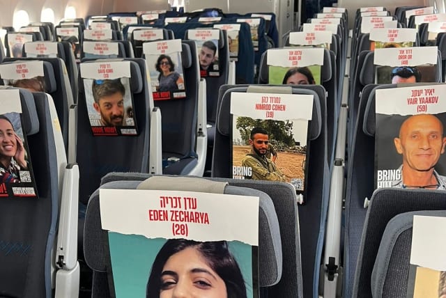  Photos of Israelis kidnapped by Hamas in Gaza fill empty seats on an El Al flight carrying military and medical equipment to Israel, October 23 2023. (photo credit: EL AL)