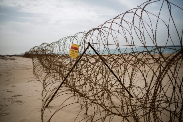  A barbed wire fence is seen on Zikim beach, in southern Israel near the border with Northern Gaza Strip, on April 5, 2016 (photo credit: CORINNA KERN/FLASH90)
