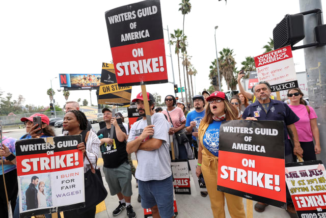  SAG-AFTRA actors and Writers Guild of America (WGA) writers walk the picket line during their ongoing strike outside Netflix offices in Los Angeles, California, US, September 22, 2023. (photo credit: REUTERS/MARIO ANZUONI/FILE PHOTO)