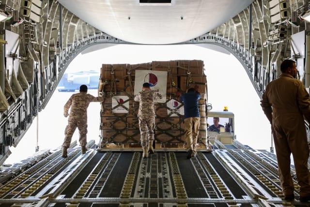  Qatari Amiri Air Force crew load food and medical aid to their cargo plane from the Qatar Fund for Development headed to Egypt for Gaza, at Al Udeid Air Base, Doha, Qatar, October 16, 2023. (photo credit: QATAR NEWS AGENCY/HANDOUT VIA REUTERS)