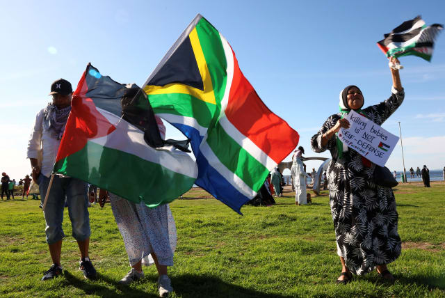  People hold Palestinian and South African flags during a demonstration in support of Palestinians at Three Anchor Bay in Cape Town, South Africa, October 22, 2023. (photo credit: ESA ALEXANDER/REUTERS)