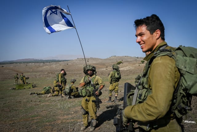 Israeli reserve soldiers seen during a military training before heading to the Israeli-Gaza border in the Golan Heights, northern Israel, on October 25, 2023 (photo credit: MICHAEL GILADI/FLASH90)