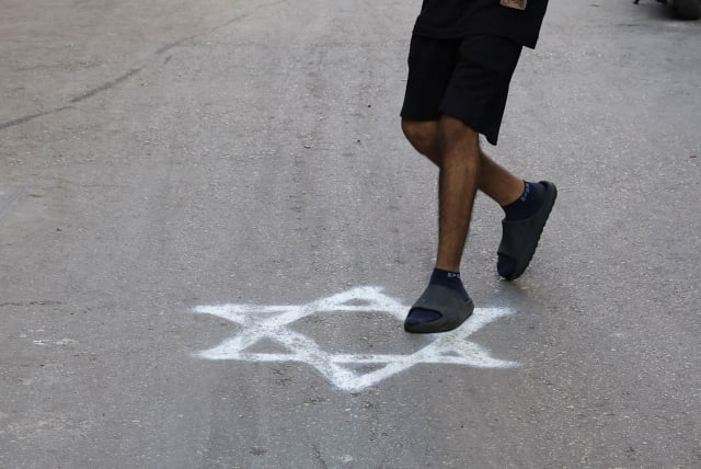  A person steps on a graffiti of the Star of David sprayed on a pavement in Bourj al-Barajneh Refugee Camp in Beirut, Lebanon, October 25, 2023 (photo credit: REUTERS/AMR ALFIKY)
