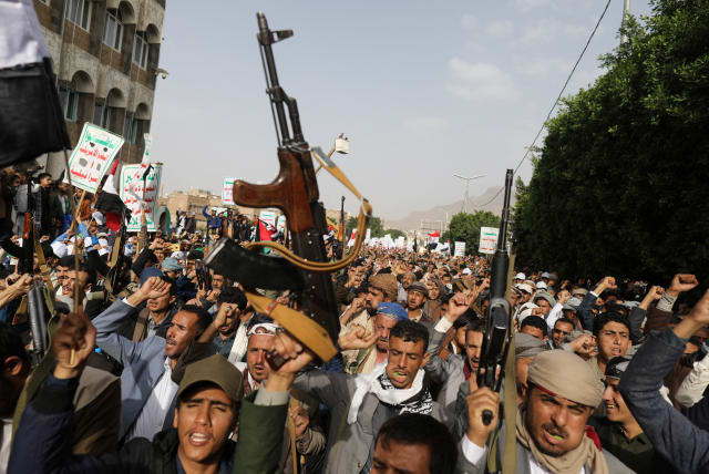  Armed men hold up their weapons as Houthi supporters rally to show support to Palestinian factions, in Sanaa, Yemen October 7, 2023 (photo credit: REUTERS/KHALED ABDULLAH)