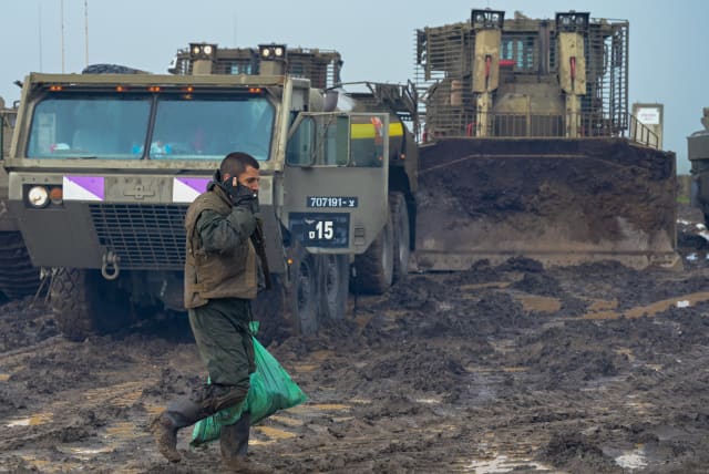  Soldiers from Givati's Shaked brigade participate in a muddy military exercise during a rainstorm near Moshav Jonathan in central Golan Heights on February 7, 2023.  (photo credit: MICHAEL GILADI/FLASH90)