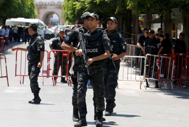  Police officers stand guard near the site of a suicide bombing attack in downtown Tunis, Tunisia June 27, 2019. (photo credit: REUTERS/ZOUBEIR SOUISSI)