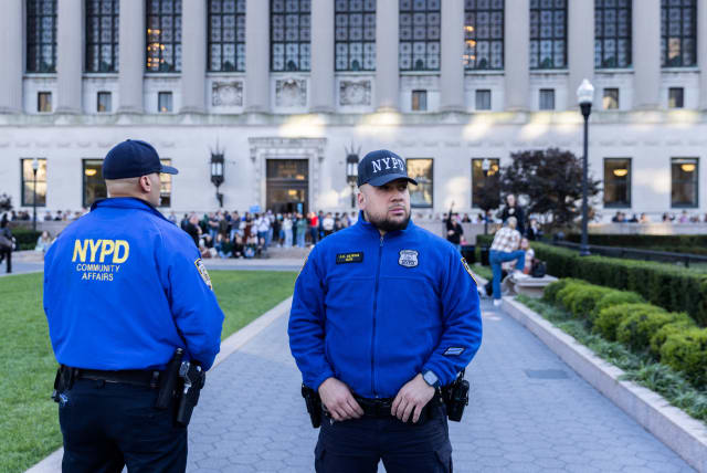 New York police officers stand guard as pro-Israel and pro-Palestinians students demonstrate, amid the ongoing conflict in Gaza, at Columbia University in New York City, US, October 12, 2023 (photo credit: JEENAH MOON/REUTERS)