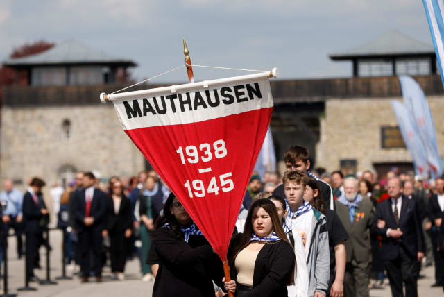  People participate in a commemoration of the liberation of the former concentration camp KZ Mauthausen, at the memorial site in Mauthausen, Austria, May 7, 2023 (photo credit: REUTERS/LEONHARD FOEGER)
