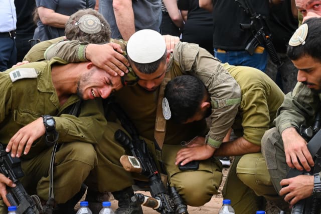  Family and friends attend the funeral of Sgt. Shoam Moshe Ben-Harush who died of his wounds after being severely injured in the Hamas terrorist on October 7, 2023, at the Haspin cemetery in northern Israel, on October 27, 2023 (photo credit: MICHAEL GILADI/FLASH90)