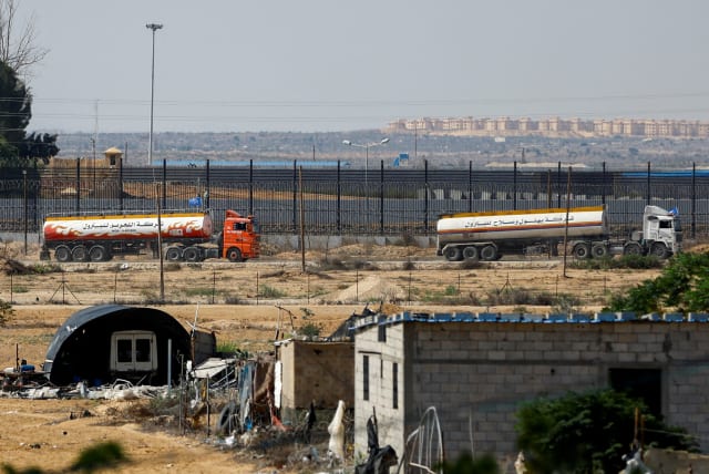  UN-flagged fuel trucks move towards the border crossing, amid the ongoing Israeli-Palestinian conflict, in Rafah in the southern Gaza Strip, October 16, 2023 (photo credit:  REUTERS/Ibraheem Abu Mustafa)
