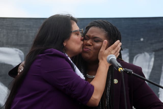  Rep. Rashida Tlaib (MI-12) kisses U.S. Rep. Cori Bush (D-MO) as they take part in a protest calling for a ceasefire in Gaza outside the U.S. Capitol, in Washington, U.S., October 18, 2023. (photo credit: REUTERS/LEAH MILLIS)