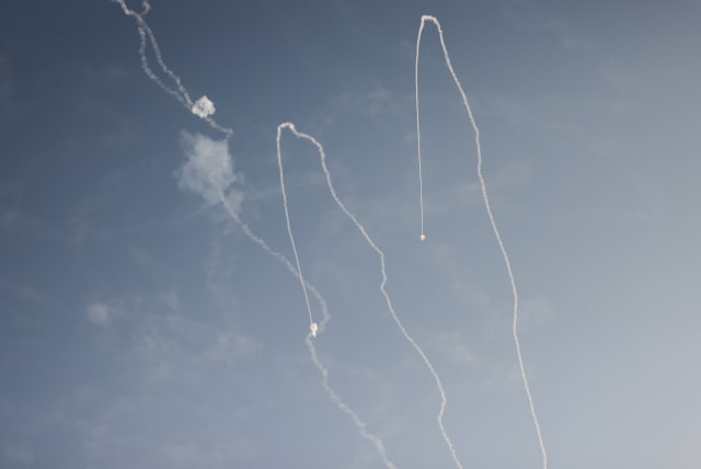  ROCKETS LAUNCHED from the Gaza Strip are intercepted by the Iron Dome air defense system, leaving smoke trails as seen in the skies over Ashkelon, during an attack last month (photo credit: Chaim Goldberg/Flash90)