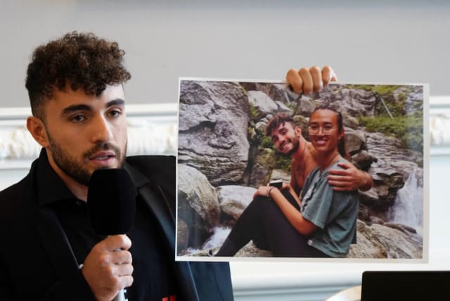  Ofir Tamir holds up a picture of his friend Noa Argamani, who was taken hostage on October 7 by Hamas, as he speaks during a press conference in Copenhagen, Denmark, October 30, 2023. (photo credit: REUTERS/Tom Little)