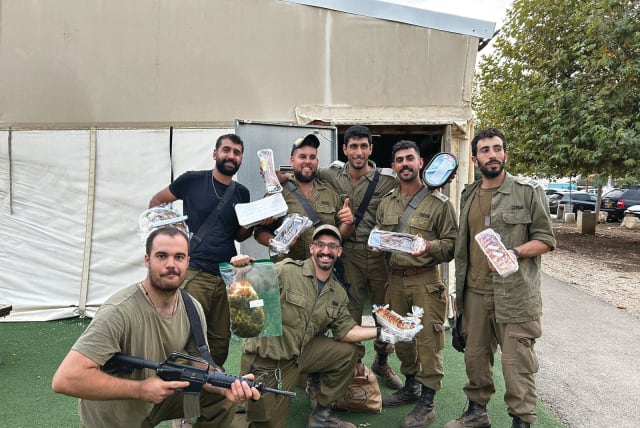 IDF SOLDIERS enjoy a delivery of baked goods. (photo credit: Hamal for Sweets)
