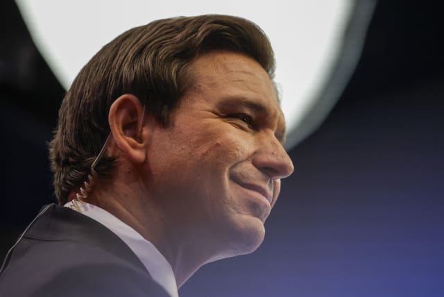 Florida Governor Ron DeSantis sits for a live television interview in the "Spin Room" after the conclusion of the third Republican candidates' U.S. presidential debate of the 2024 U.S. presidential campaign. November 8, 2023. (photo credit: REUTERS/MARCO BELLO)