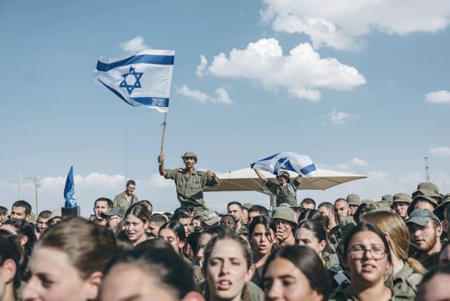  SOLDIERS DANCE at a concert by singer Idan Raichel at an army base in the South, last month. In these days of trauma and war there may be room for optimism, says the writer. (photo credit: CHEN SCHIMMEL/FLASH90)