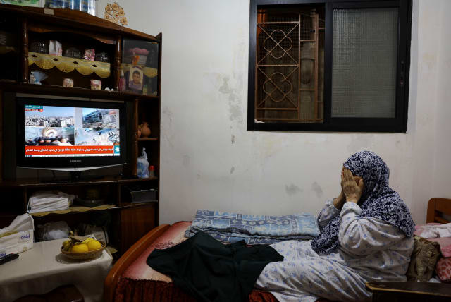  A Palestinian-Lebanese woman gestures while watching news on television at her residence in Beirut, Lebanon, October 25, 2023 (photo credit: REUTERS/AMR ALFIKY)