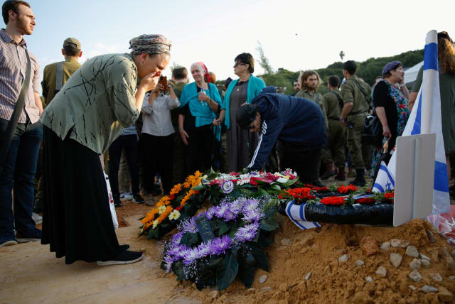 A mother of Israeli soldier Yedidya Asher Lev, who was killed in the northern Gaza Strip amid the ongoing ground operation of the Israeli army against Palestinian terrorist group Hamas, reacts at his funeral, in the Israeli settlement Heinanit, in the West Bank, November 15, 2023. (photo credit: REUTERS/SHIR TOREM)