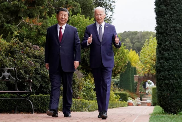  US President Joe Biden gives thumbs-up as he walks with Chinese President Xi Jinping at Filoli estate on the sidelines of the Asia-Pacific Economic Cooperation (APEC) summit, in Woodside, California November 15th. (photo credit: REUTERS/KEVIN LAMARQUE)