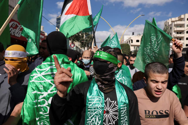  Palestinians take part in a protest in support of Hamas, in Hebron, the West Bank, November 17, 2023 (photo credit: REUTERS/MUSSA QAWASMA)