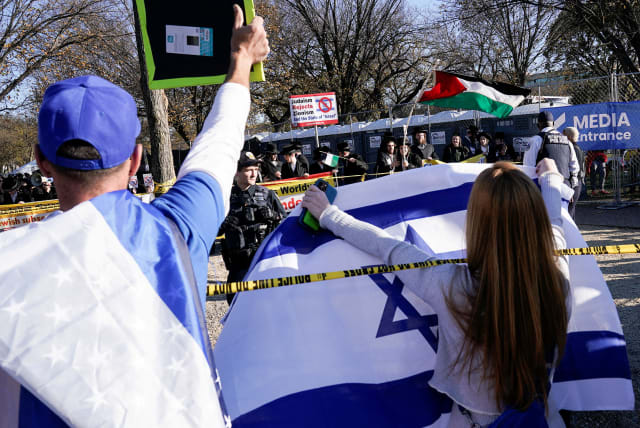  A rally goer holds up an Israeli flag towards counter protesters, as Jewish Americans and supporters of Israel gather in solidarity with Israel and protest against antisemitism, amid the ongoing conflict between Israel and Hamas, in Washington, U.S, November 14, 2023. (photo credit: REUTERS/Elizabeth Franz)