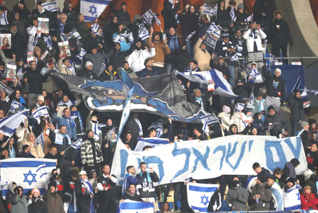  ISRAEL FANS display flags and signs during the blue-and-white’s Euro 2024 qualifier against Romania on Saturday night at Pancho Arena in Felcsút, Hungary. (photo credit: Bernadett Szabo/Reuters)