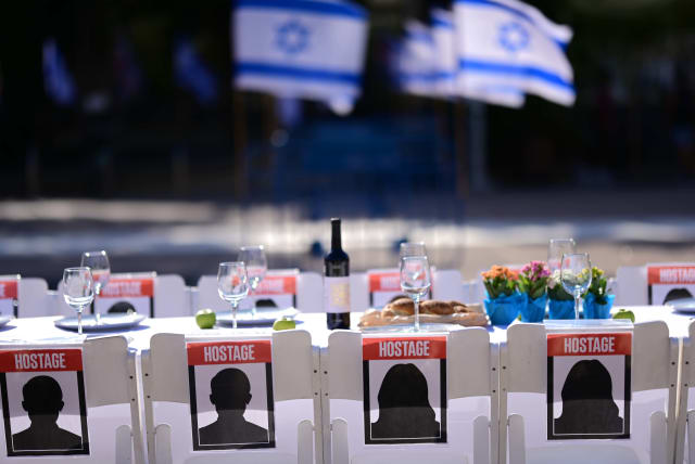  Families of Israelis held hostage by Hamas militants in Gaza set a symbolic shabbat table with more than 200 empty seats for the hostages, at  "Hostage Square", outside the Art Museum of Tel Aviv, October 20, 2023.  (photo credit: TOMER NEUBERG/FLASH90)