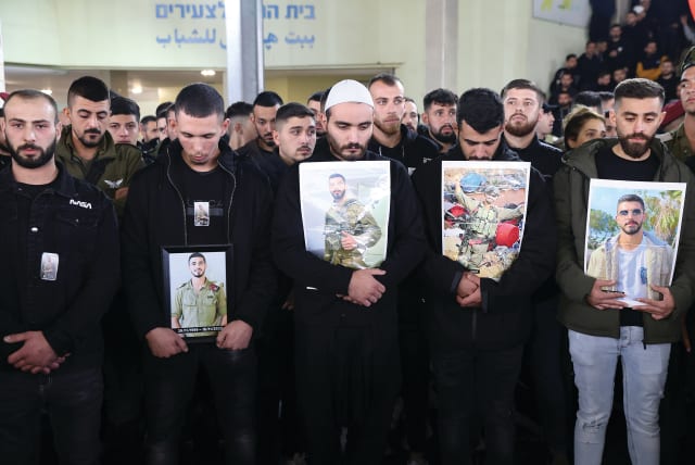  FAMILY AND FRIENDS of Maj. Jamal Abbas mourn at his funeral in the village of Peki’in earlier this week, after he was killed during a ground operation in the Gaza Strip. (photo credit: David Cohen/Flash90)