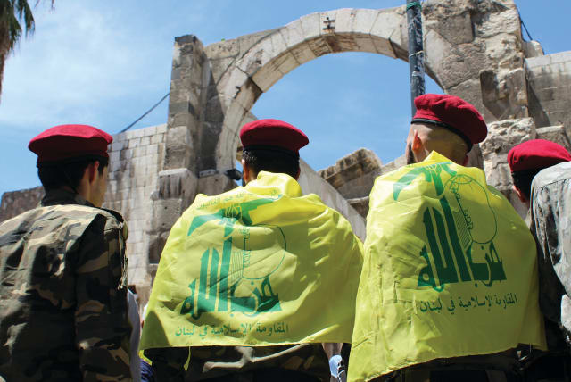  PALESTINIANS LIVING in Syria wear Hezbollah flags at a demonstration in Damascus marking the annual al-Quds Day. (photo credit: FIRAS MAKDESI/REUTERS)