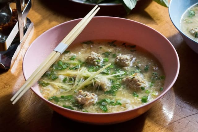 A meal in a bowl. Thai Khao Tom soup based on rice with chicken meatballs (photo credit: DROR EINAV)